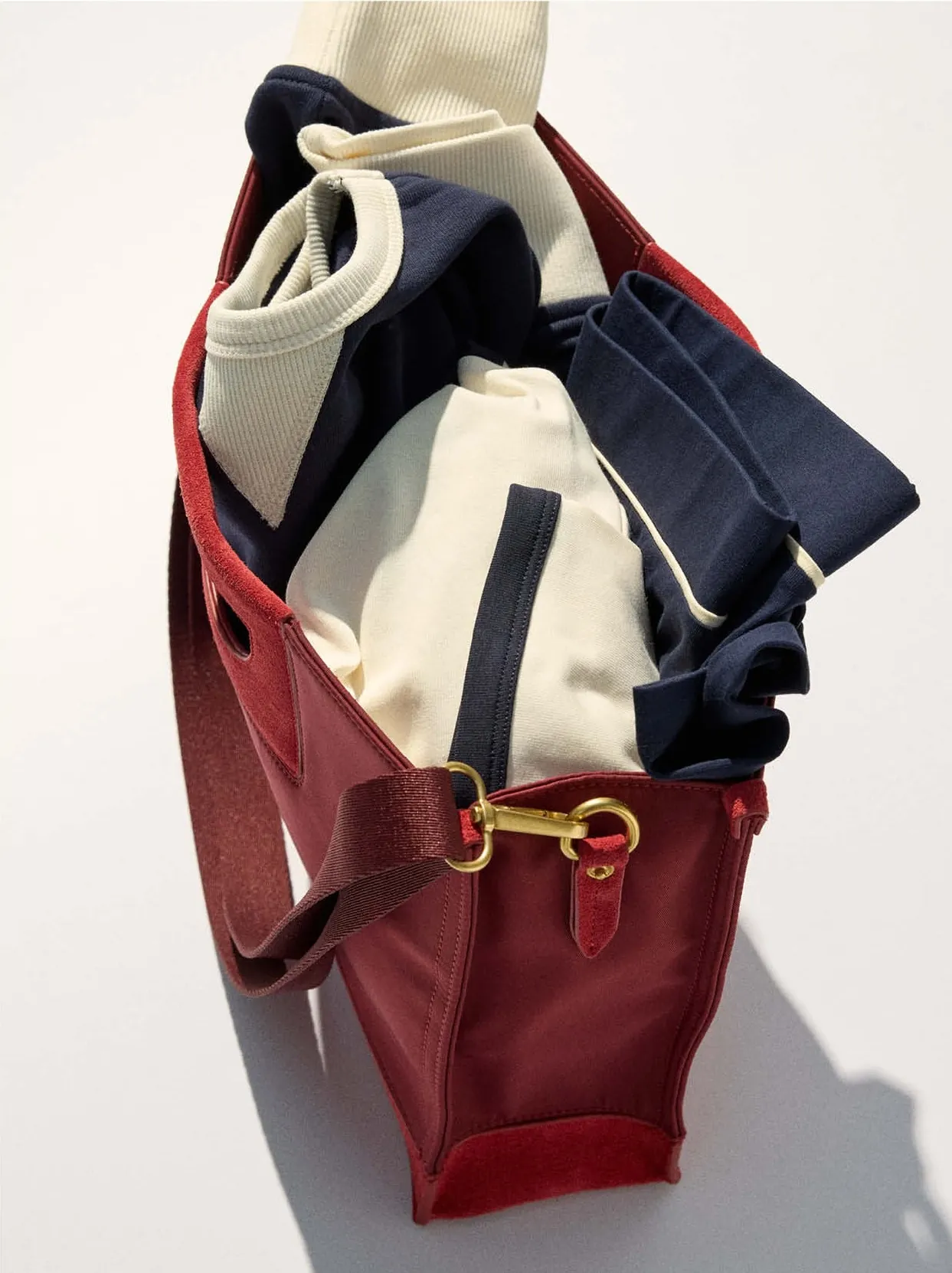The red tote packed with the navy, cream and grey pieces