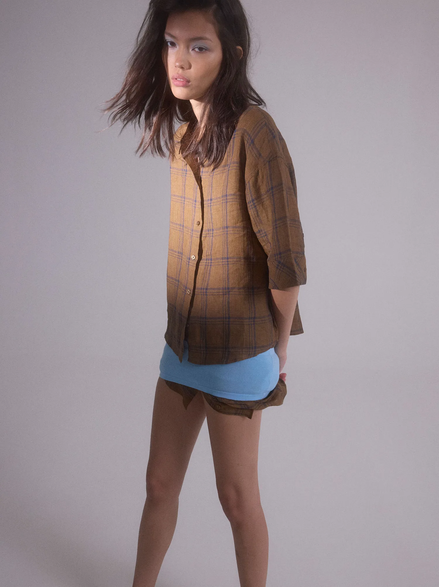 Look 02 — checked coat over a denim skirt