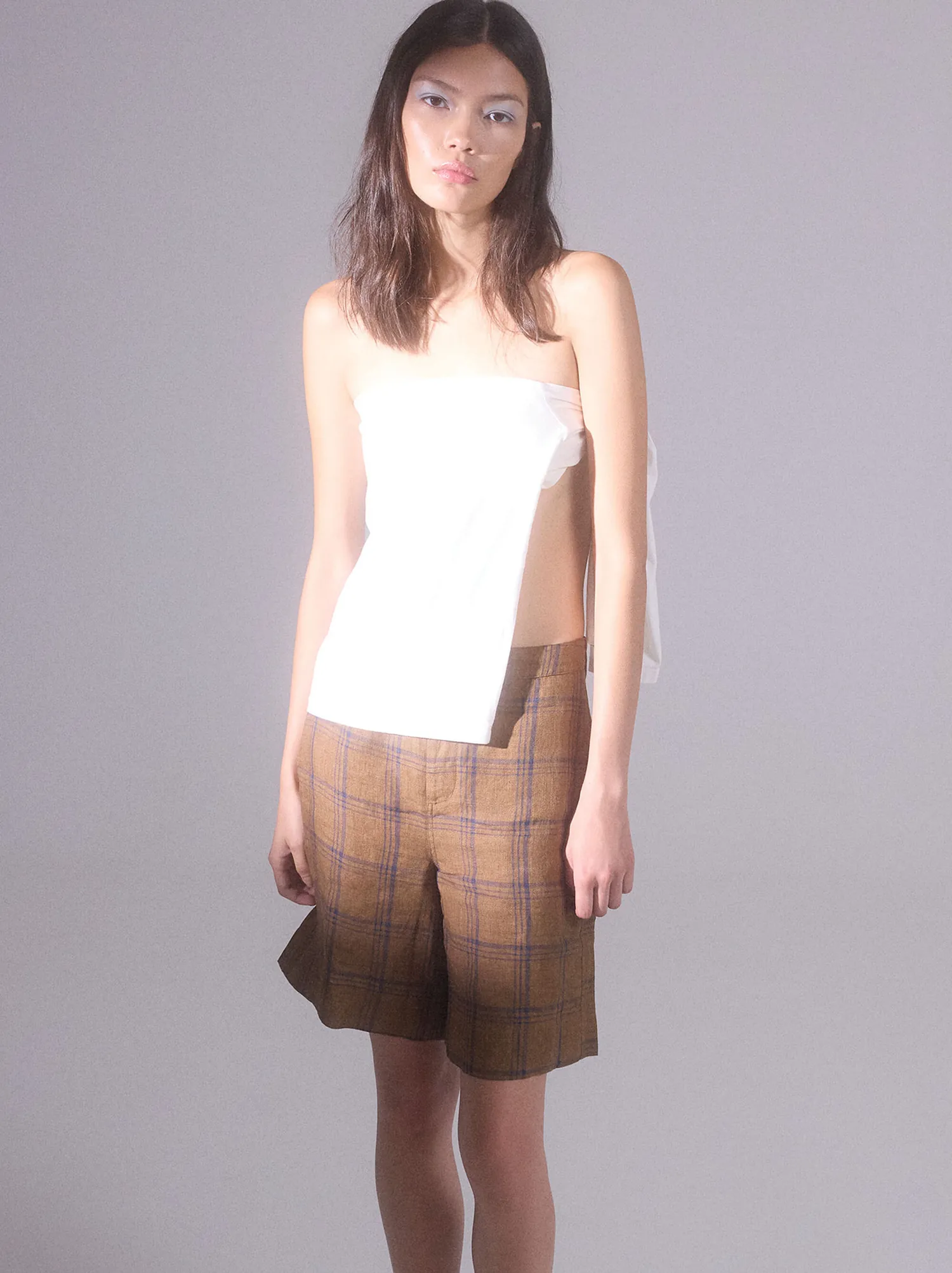 Linen co-ord in sand, photographed against a whitewashed wall