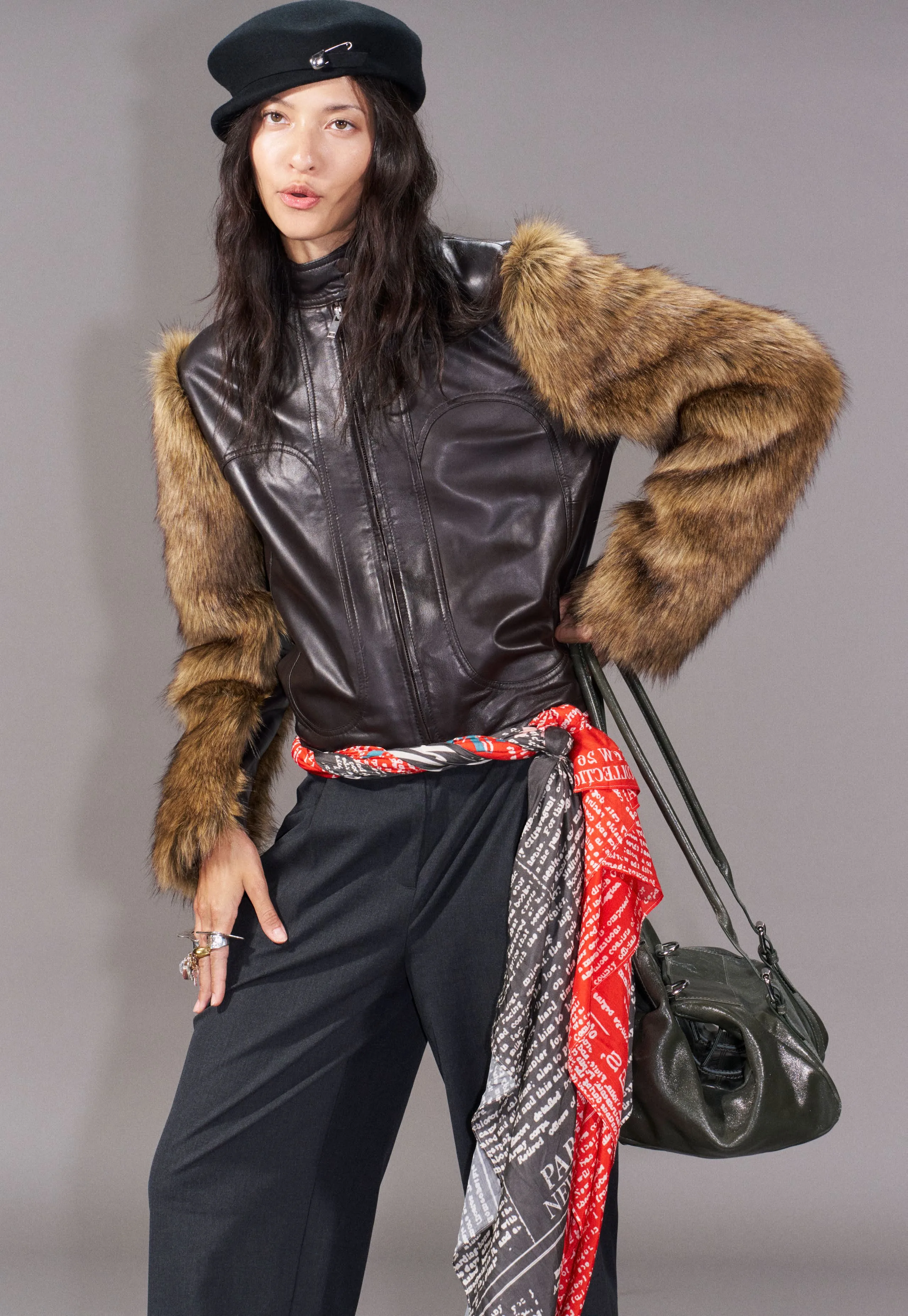 Leather vest with fur sleeves and a printed sash