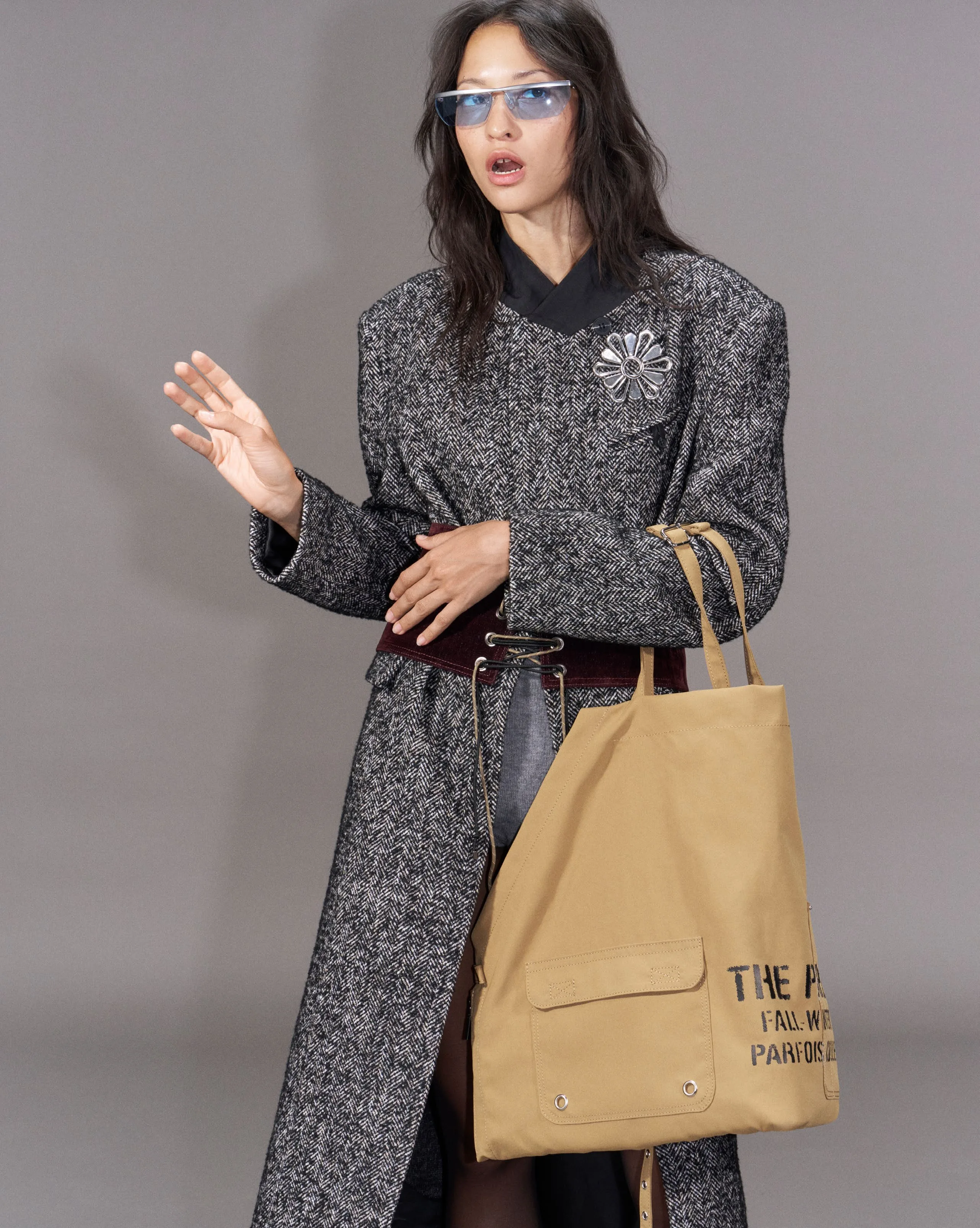 Grey herringbone coat with a tan canvas tote lettered by hand