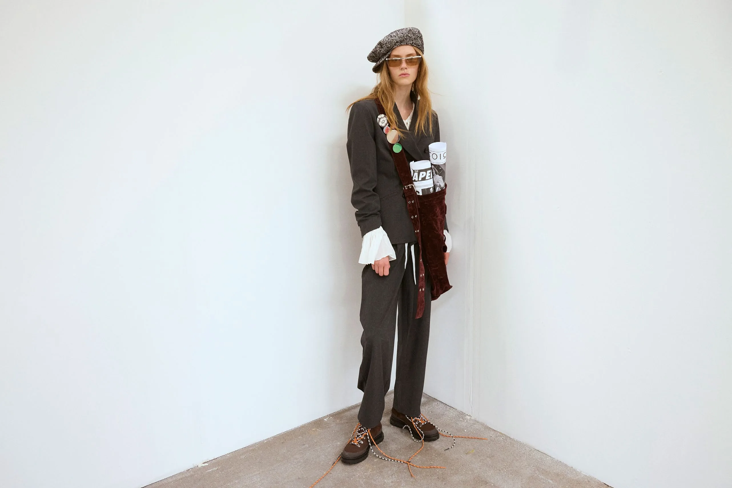 Candidate standing against the studio wall, paper in pocket