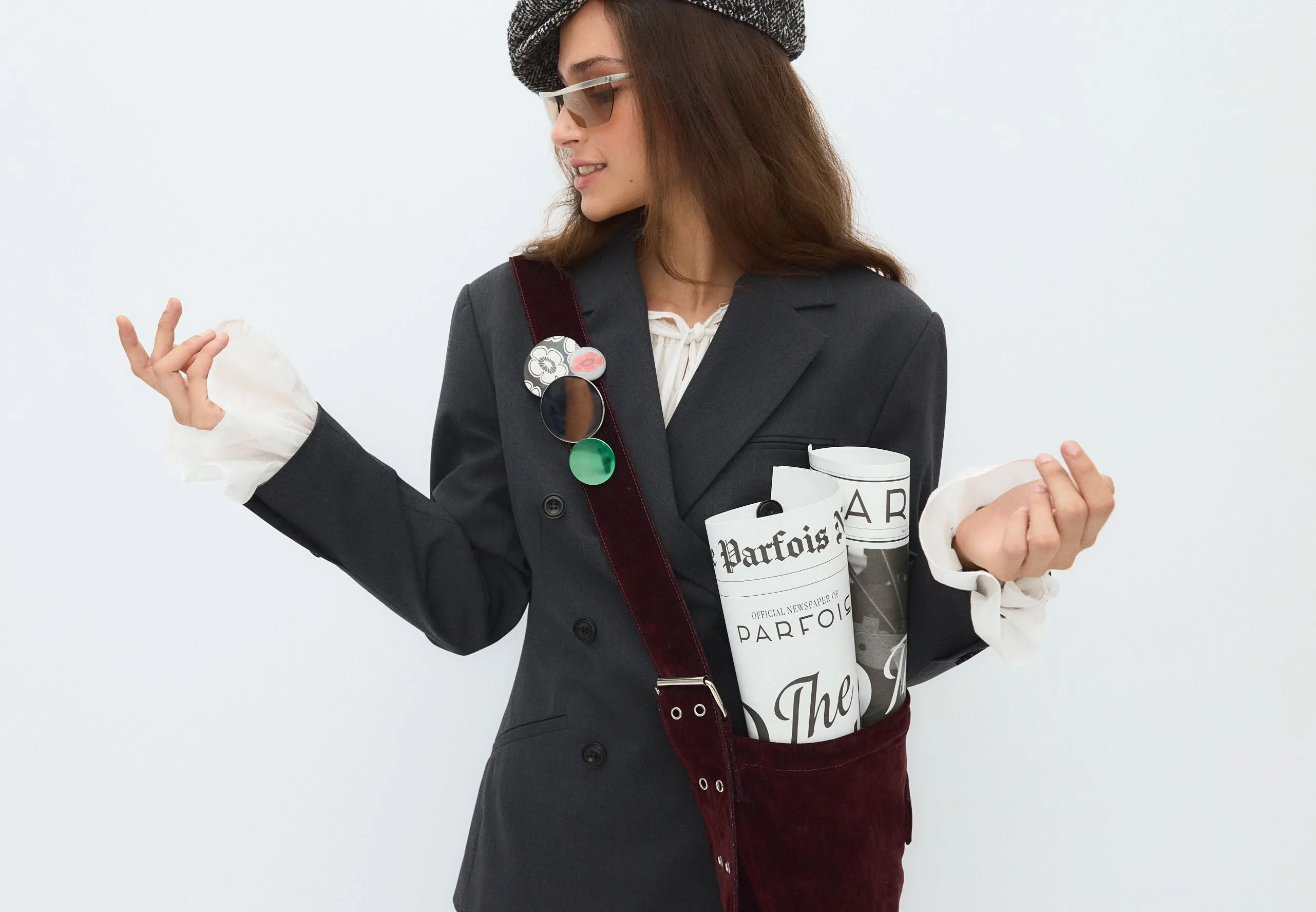 Grey blazer mid-audition, newspaper tucked under one arm