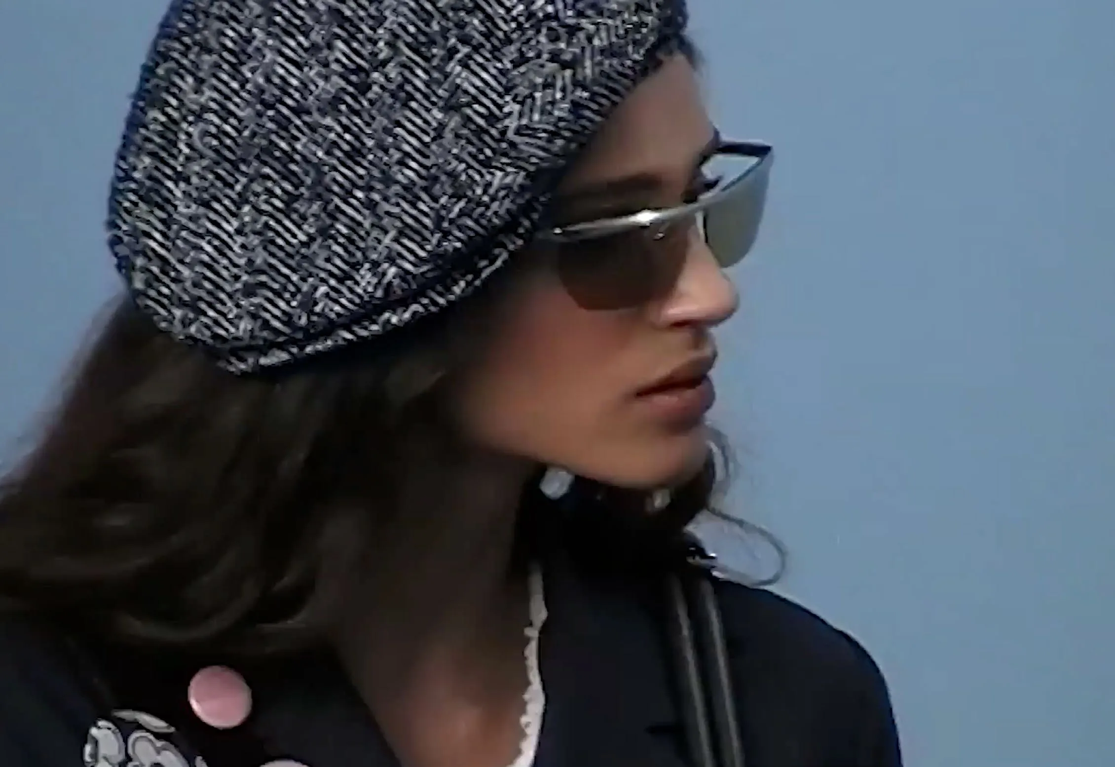 Herringbone beret and slim sunglasses, in profile