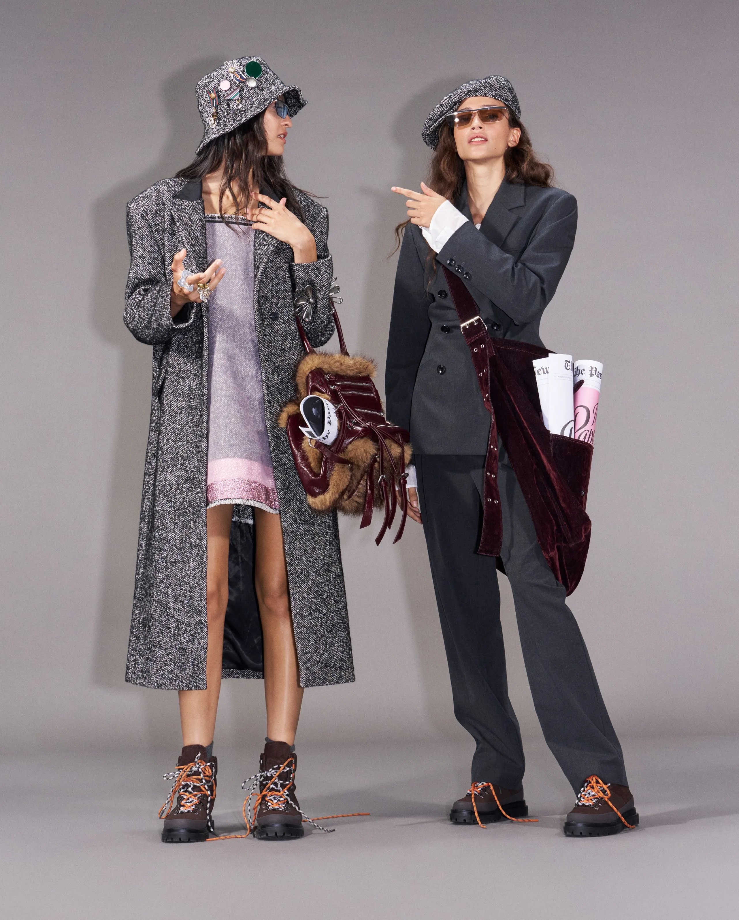 Two candidates in grey tweed pointing offstage