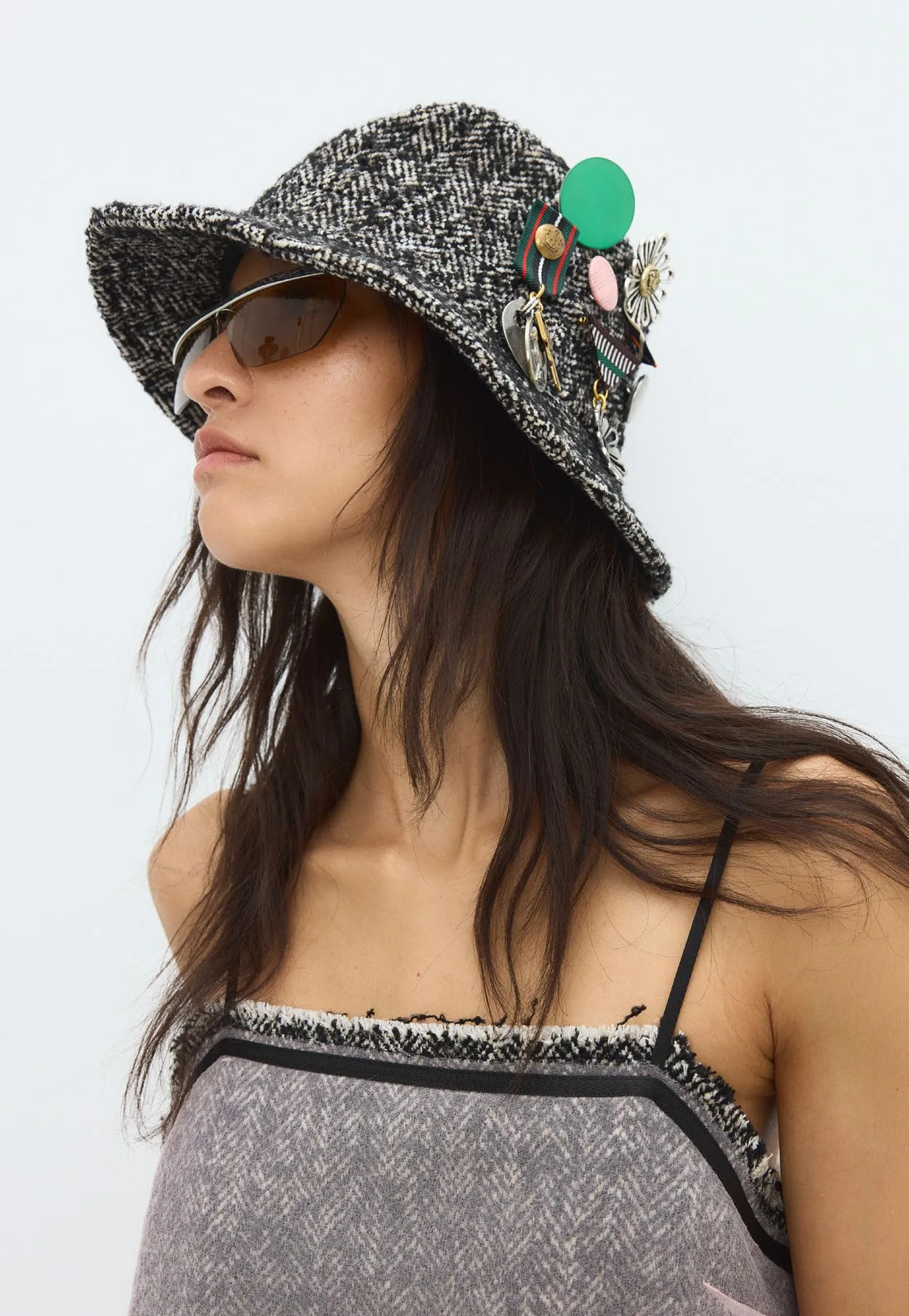 Washed grey camisole under an embellished bucket hat