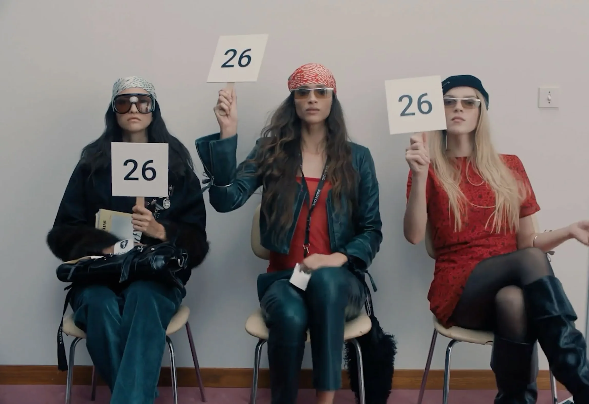 Casting tape: three candidates hold up paddles numbered 26